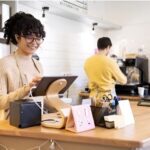 hospitality award - picture of a lady at a till and a man making coffee